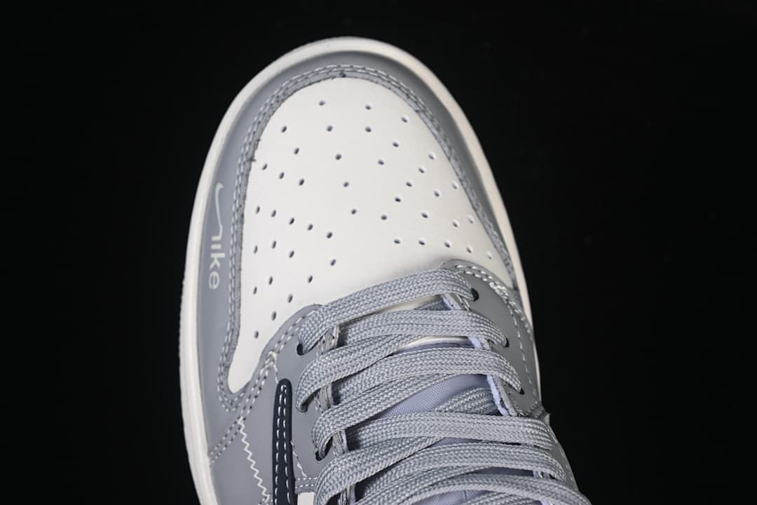 Top view of the perforated off-white toe box and gray laces.