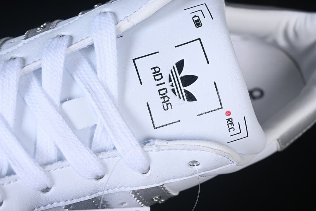 Close-up of the white tongue with adidas trefoil branding