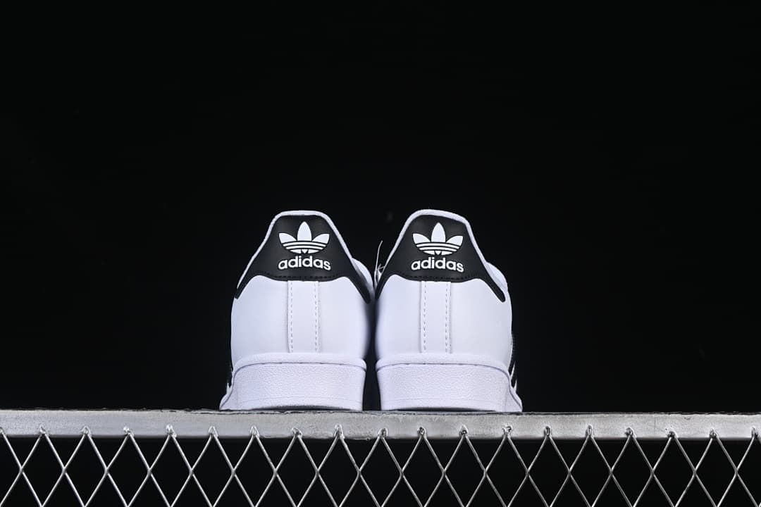 Rear view of both sneakers with contrasting black heel tabs