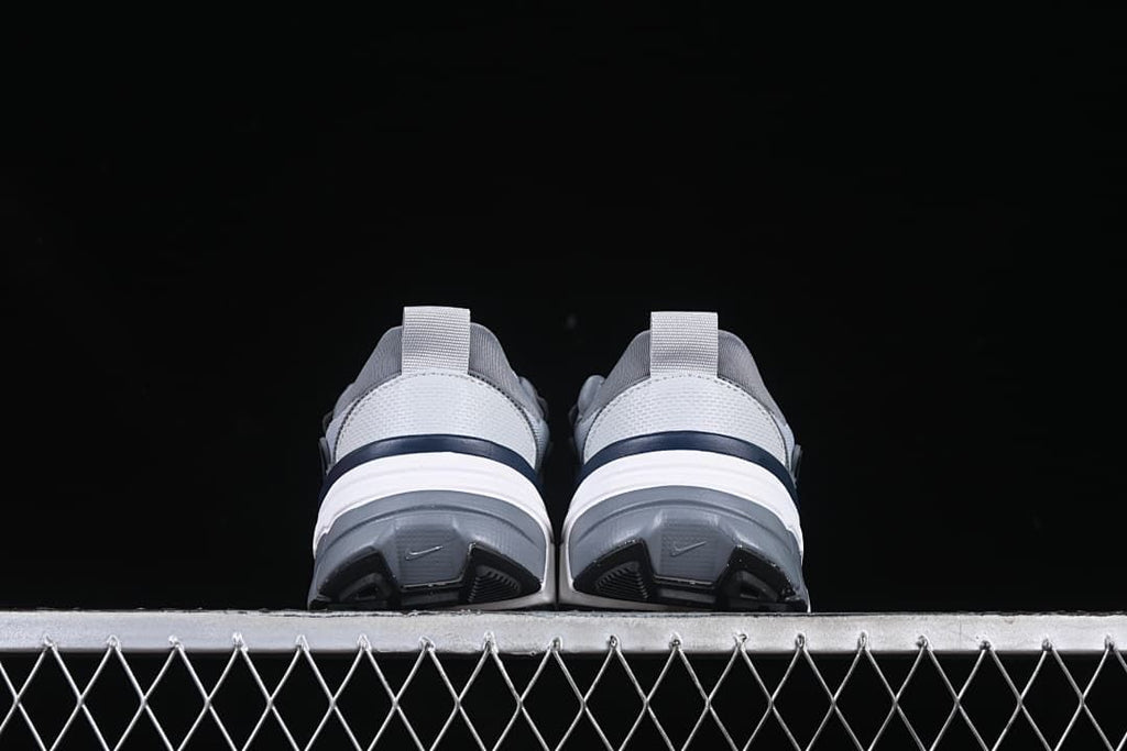 Rear view of both sneakers showing the heels and outsoles