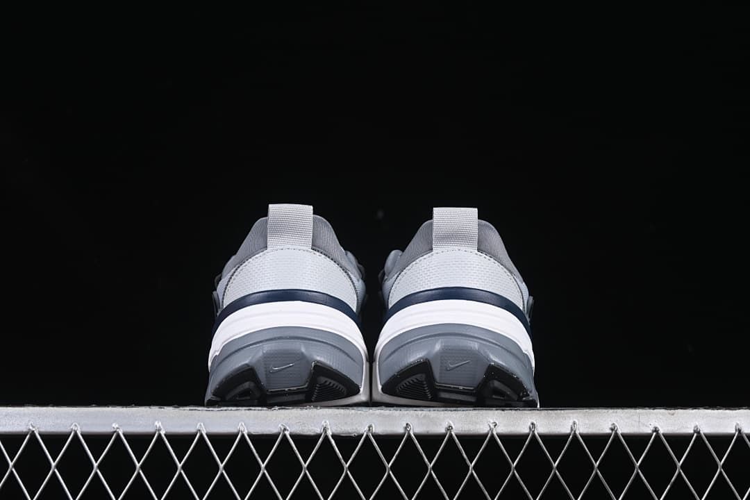 Rear view of both sneakers showing the heels and outsoles