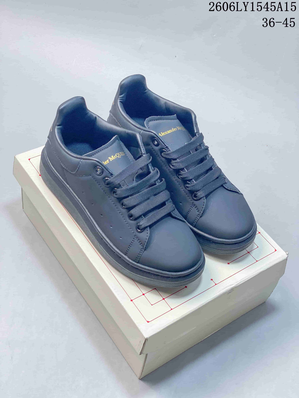 Pair of dark grey low-top sneakers with matching laces and soles.