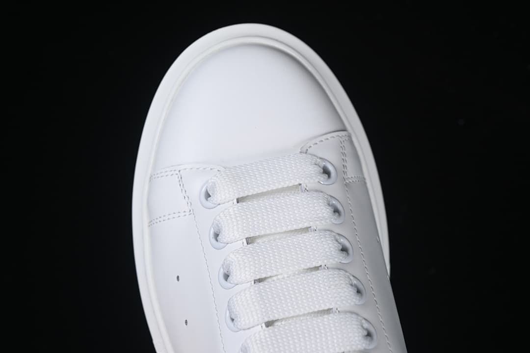 Top view of the sneaker's rounded toe and white lacing.