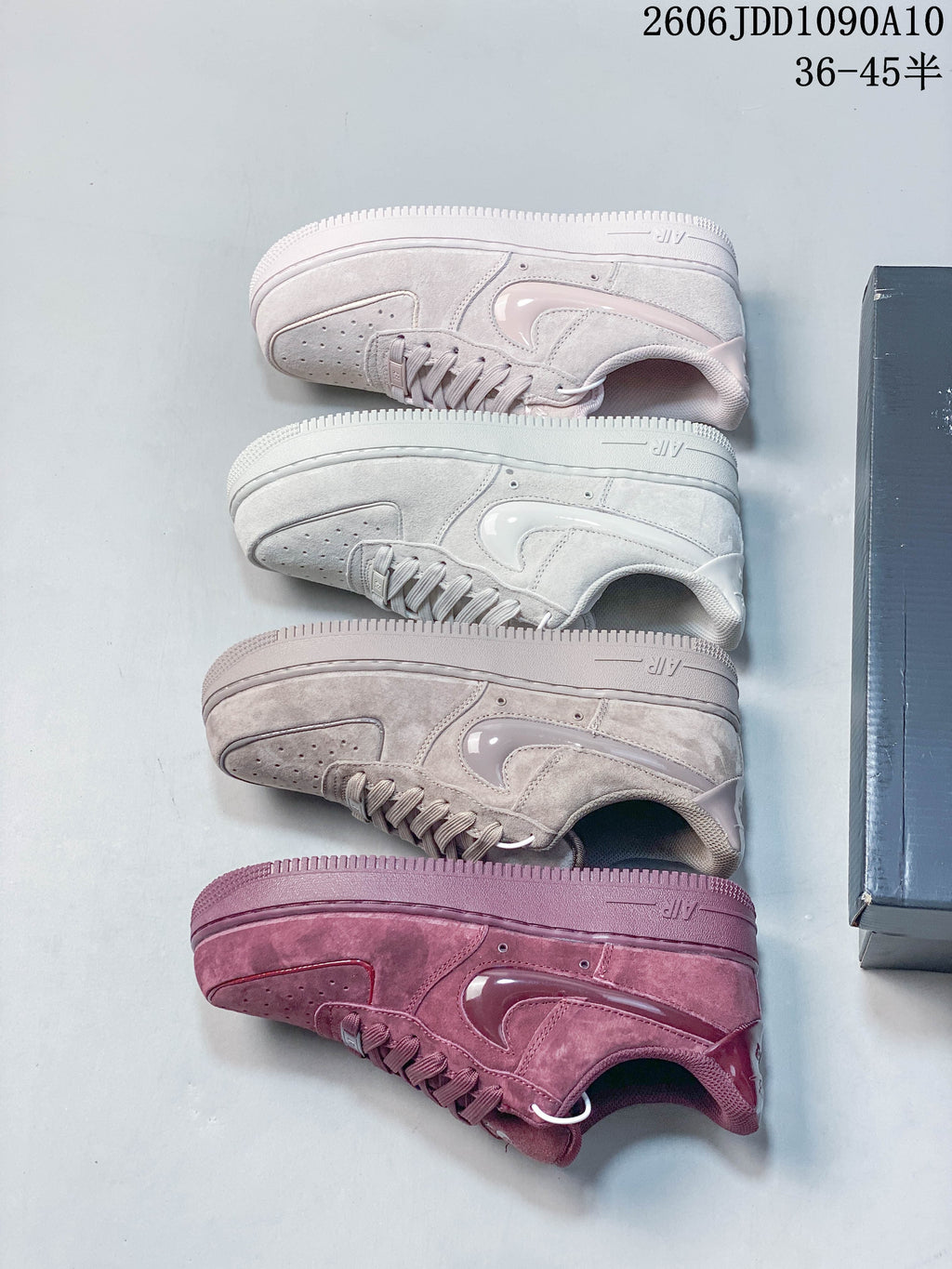 Pair of mauve Nike Air Force 1 low-top sneakers displayed on a shoe box.