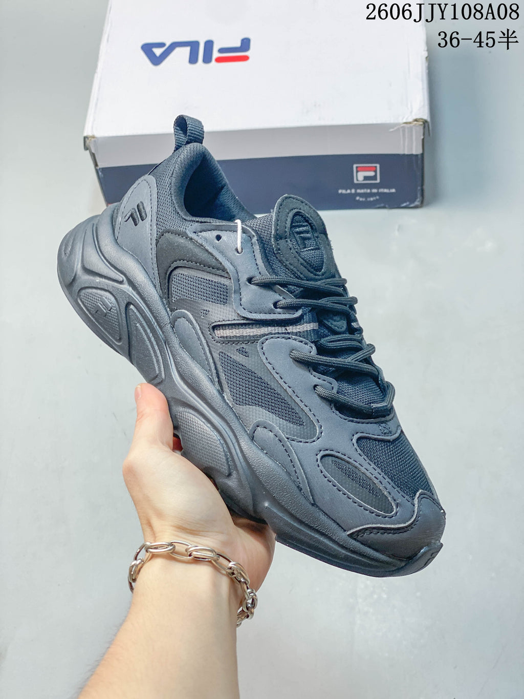 Blue-gray FILA Fusion sneaker shown from the side and front