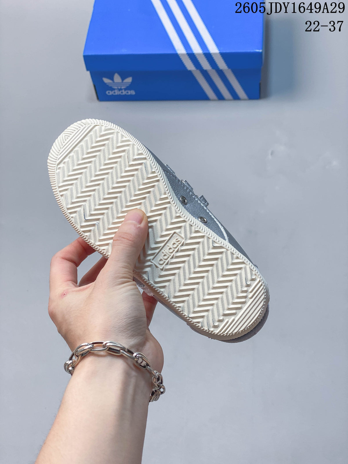 Close view of the light-colored outsole with a zigzag tread pattern