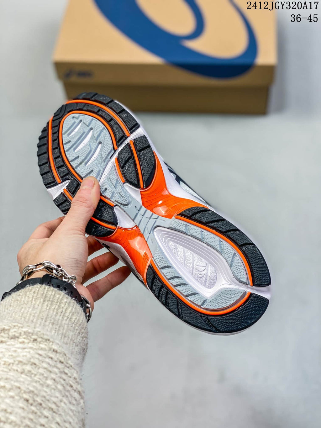 Underside of the ASICS GEL-1090 sneaker showing its patterned outsole and orange accents