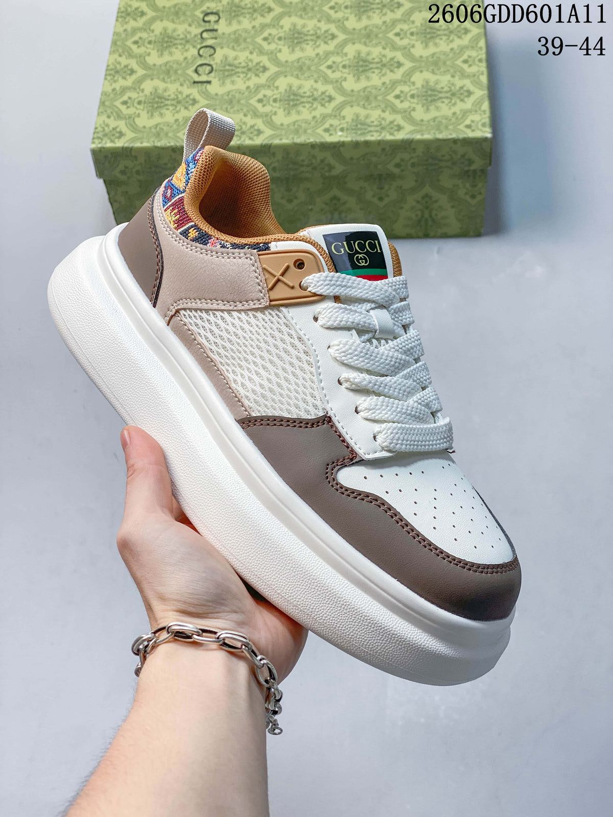 Angled view of a white and taupe sneaker with mesh side panels