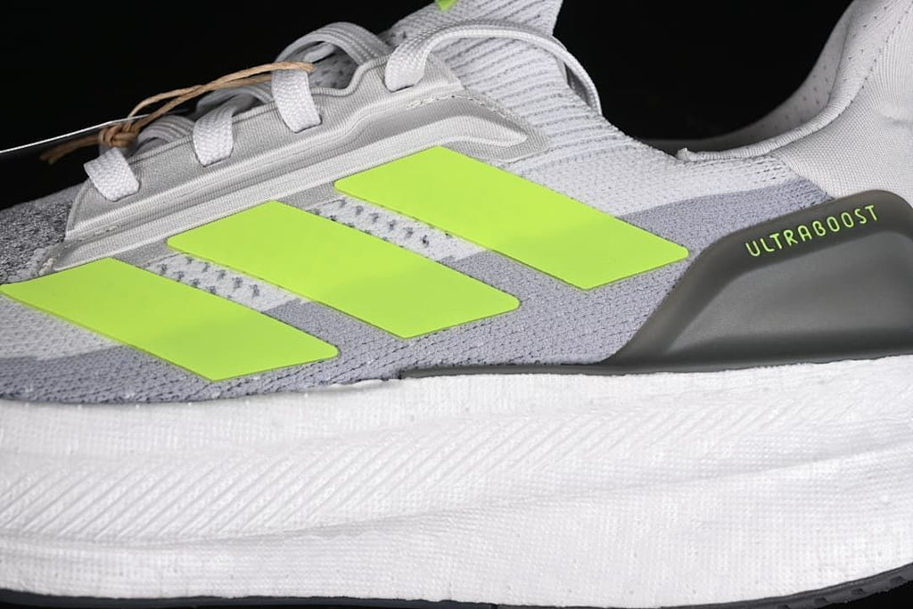 Close-up of the lime side stripes and Ultraboost heel detail.