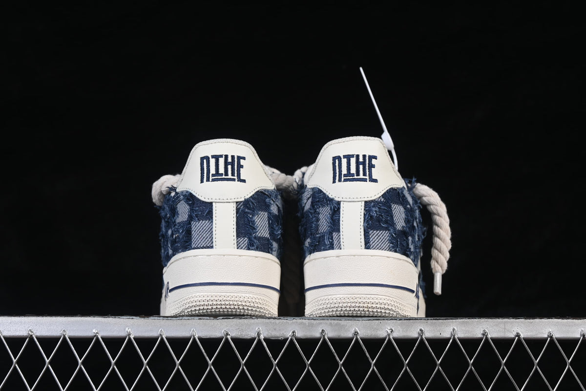 Rear view of the pair showing denim-style heel panels and off-white heel tabs
