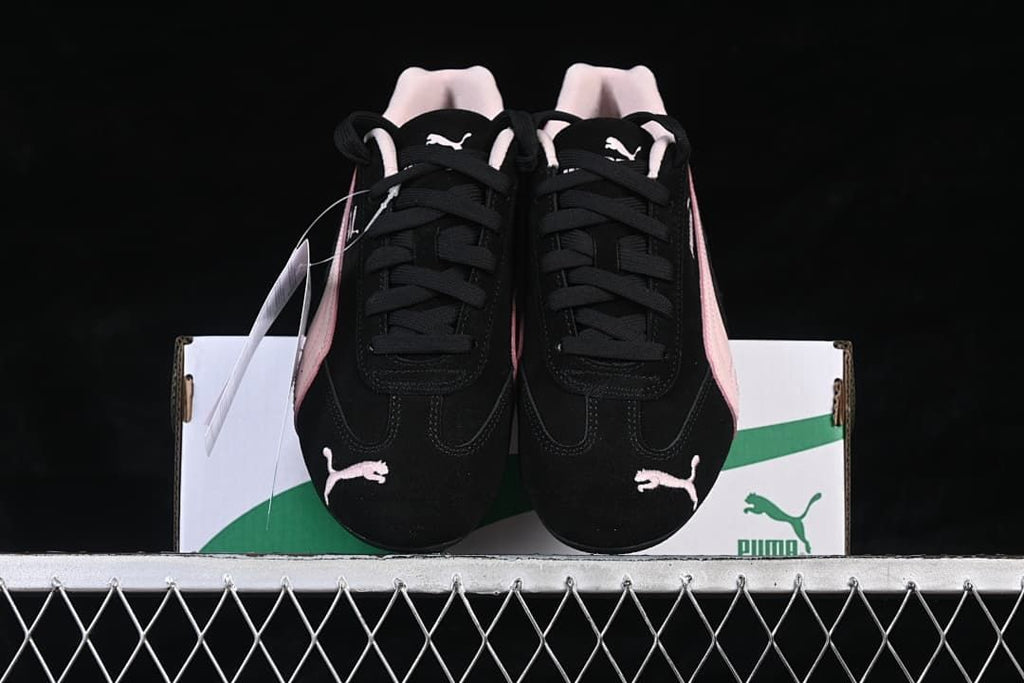 Front view of the pair showing the laces, toe logos, and pink side accents.