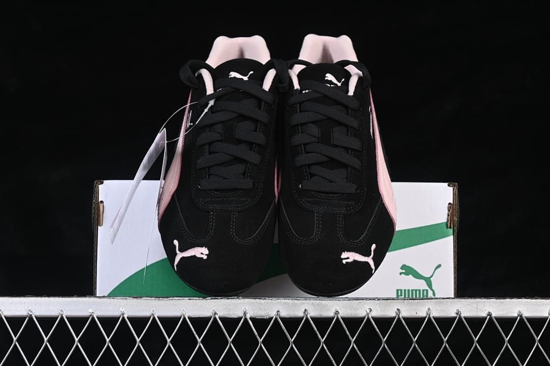 Front view of the pair showing the laces, toe logos, and pink side accents.
