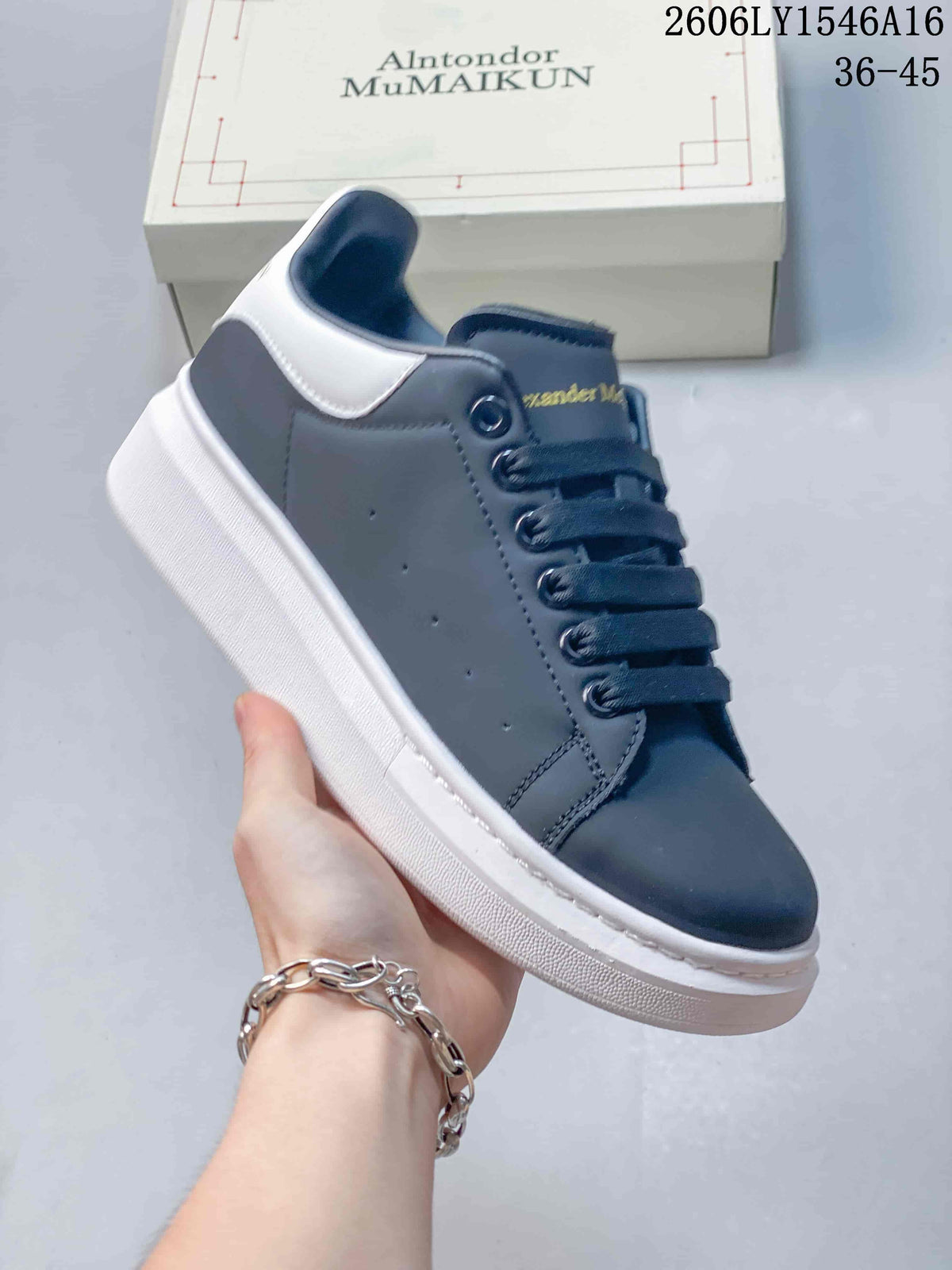 Angled side view of a navy low-top sneaker with a white heel panel