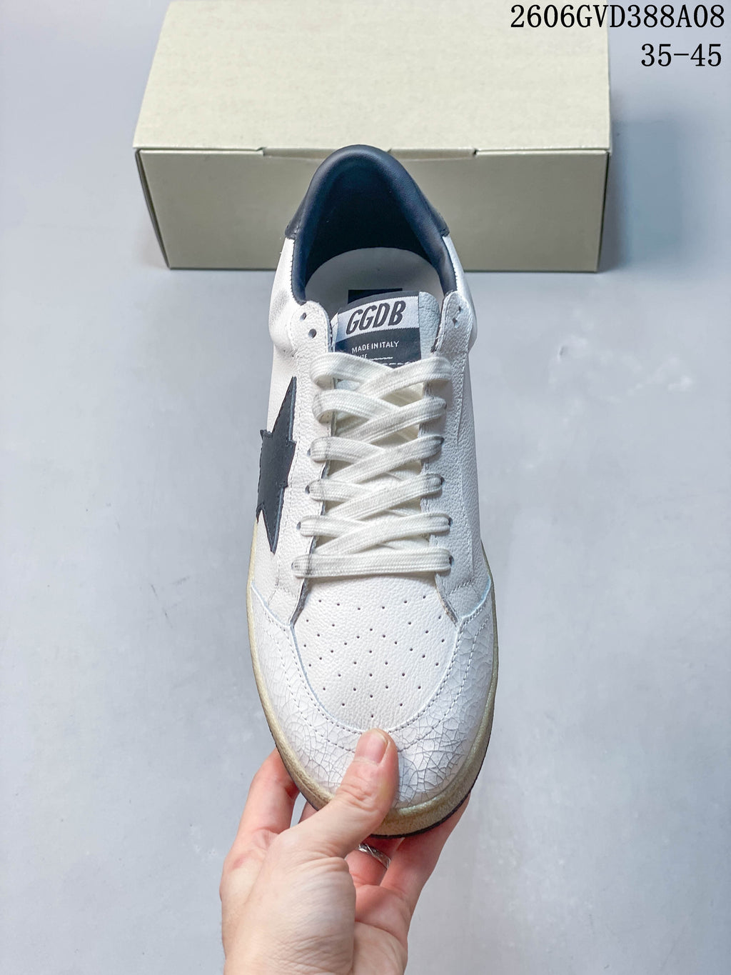 Front view of the sneaker with white laces and perforated toe