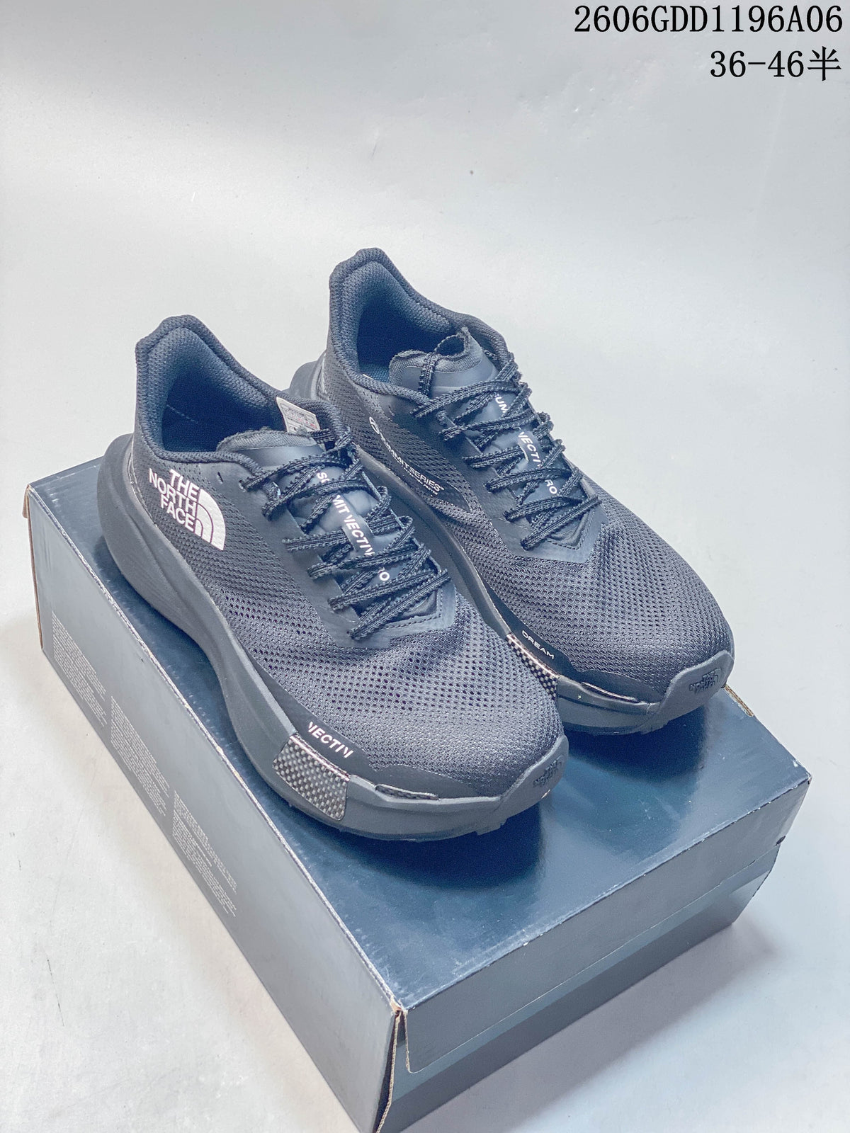 Pair of gray The North Face Summit trail shoes on a shoebox