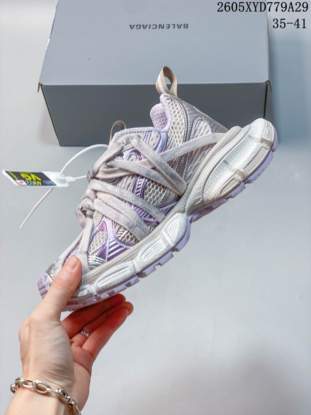 Side view highlighting layered panels, laces, and chunky outsole