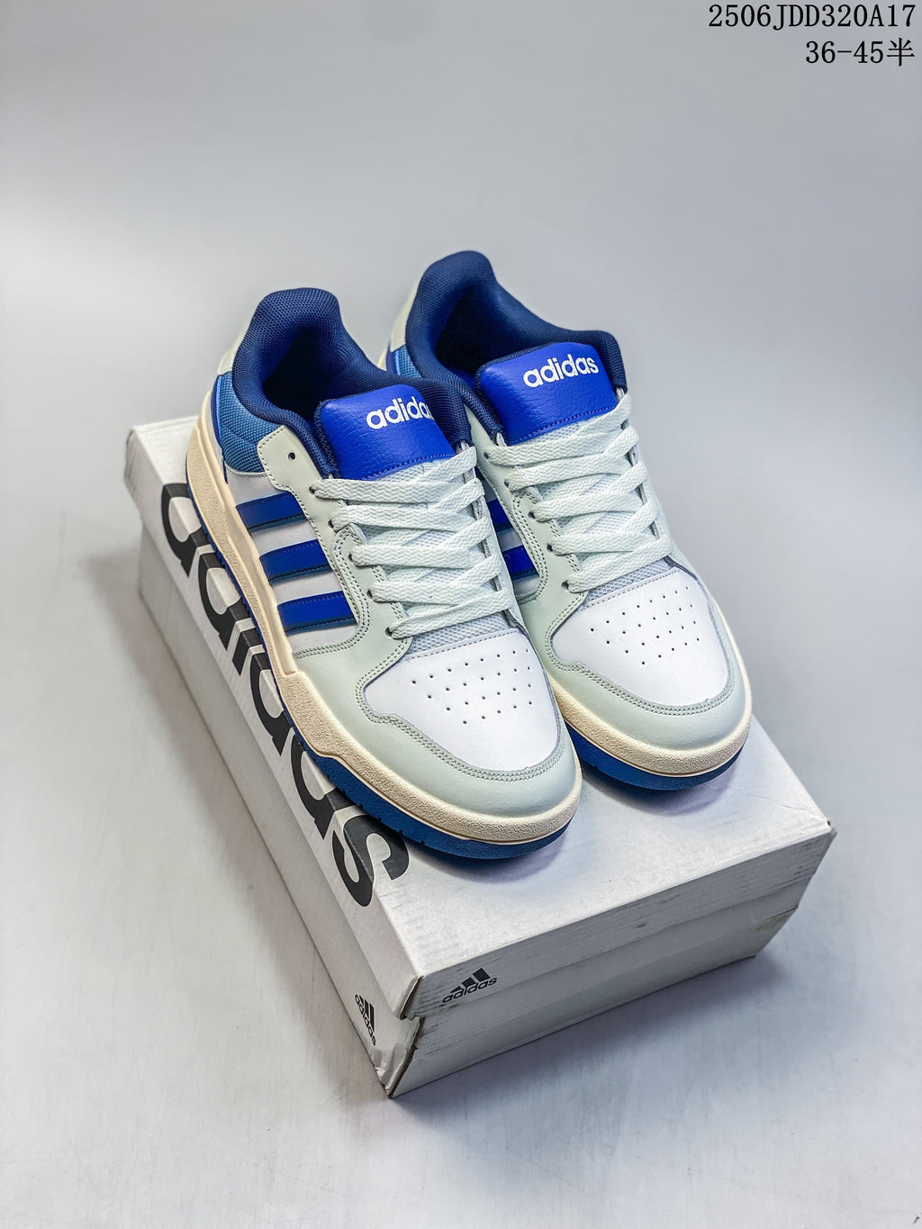 Pair of white and royal blue adidas Entrap sneakers displayed on a shoebox