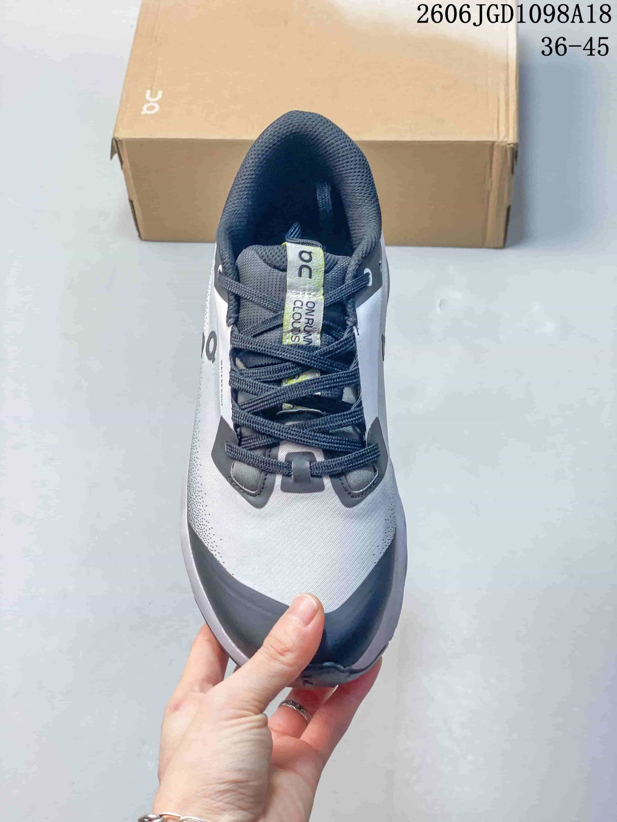 Top view of the shoe showing its lace-up front and gray upper with navy details