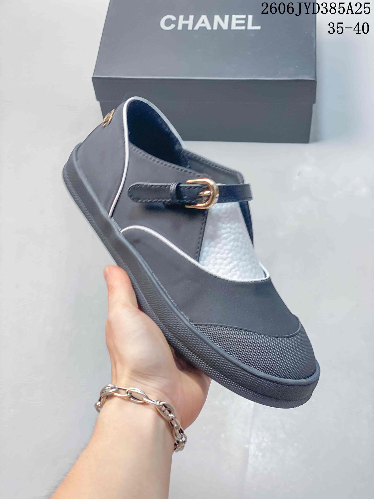 Side view of a dark gray Mary Jane flat with white piping, a buckle strap, and a low sole; size range 35–40 shown.