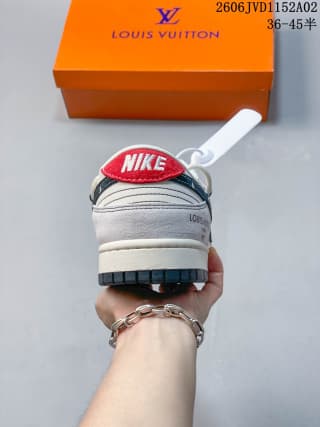 Rear view showing the heel branding details, red-and-white pull tab, and layered gray outsole.