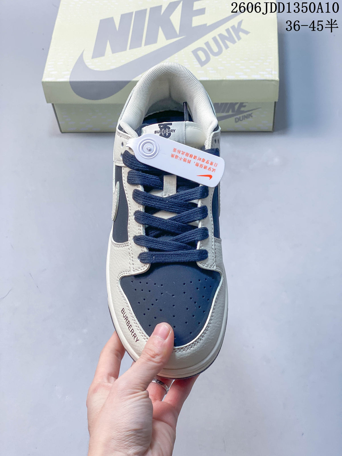 Top view of the sneaker showing navy laces, a perforated toe, and branding