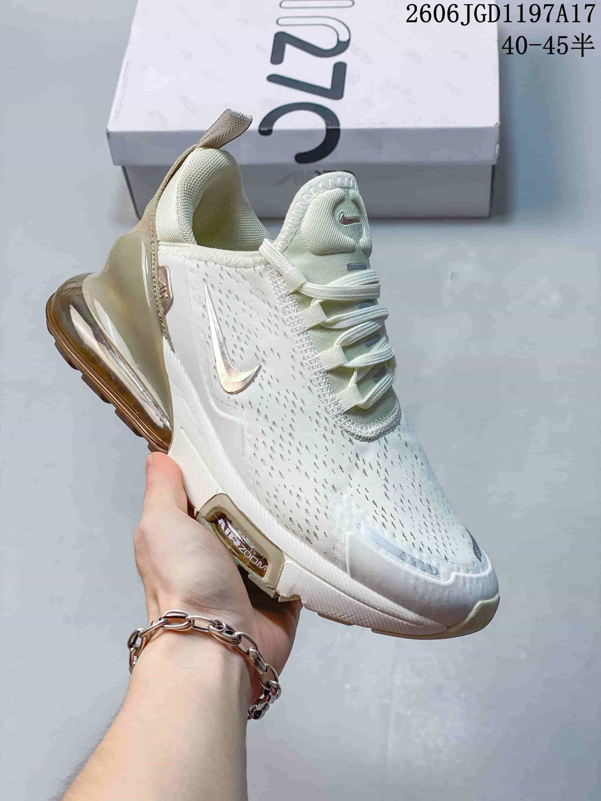 Close-up of a white Nike Air Max Pulse shoe with bronze-toned accents and a visible heel air unit.