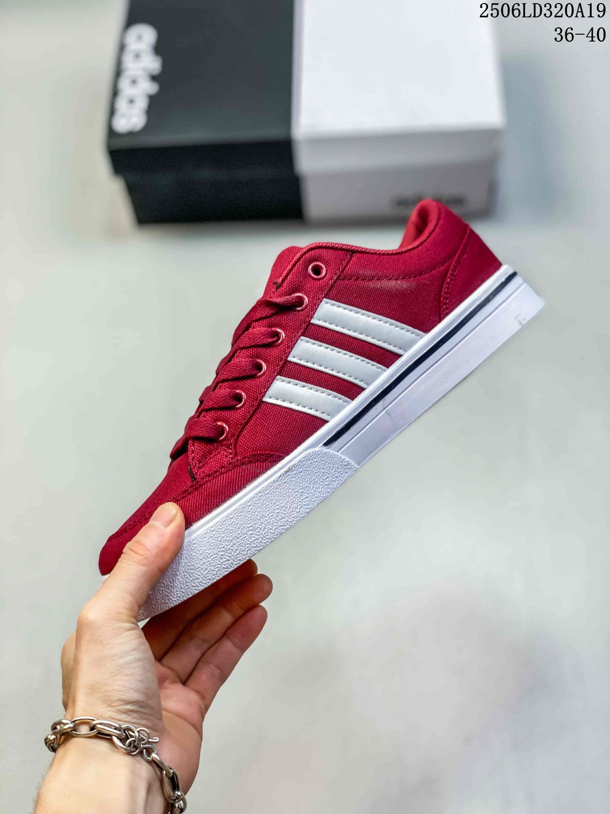 Side view of a burgundy low-top sneaker with white stripes and a white sole.