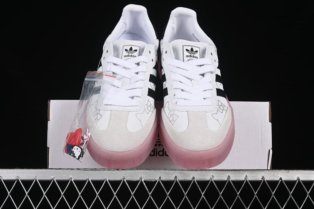 Front view of the pair showing the laces, toe panels, and pink soles.