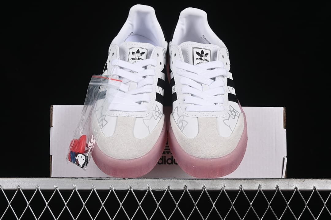 Front view of the pair showing the laces, toe panels, and pink soles.