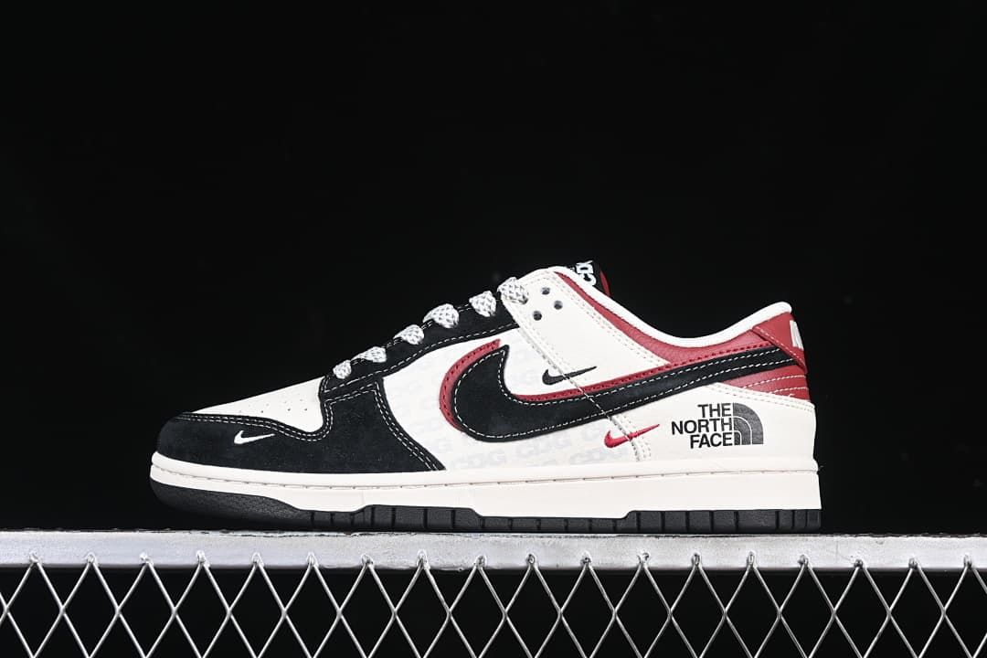 Side view of white, black, and red low-top sneakers with North Face graphics