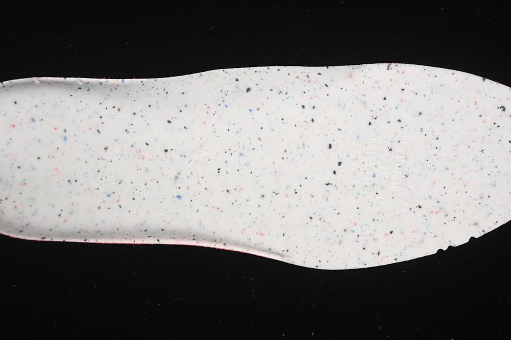 White shoe insole shown from above with multicolored speckles