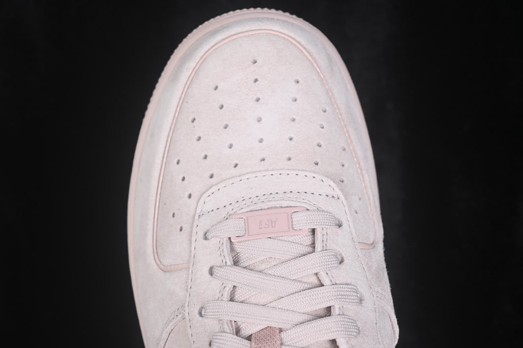 Close-up view of the perforated toe box and flat woven laces.