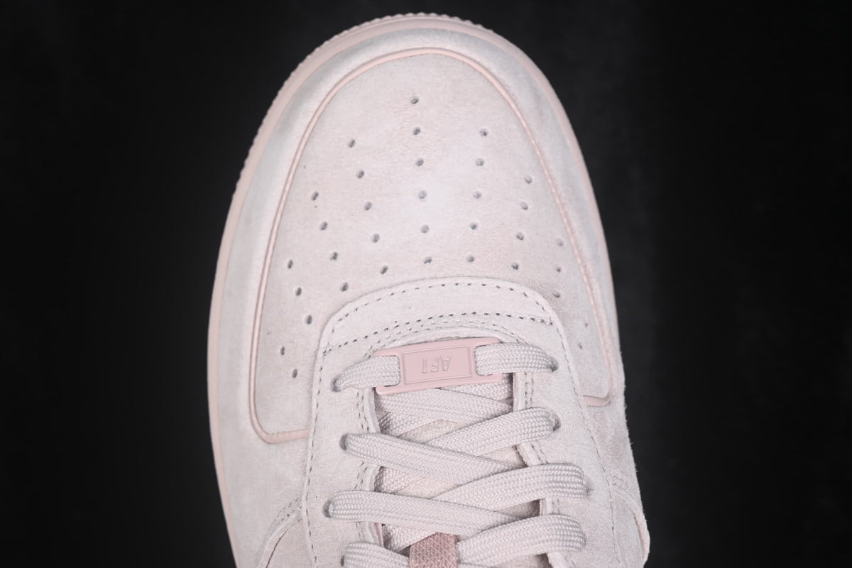 Close-up view of the perforated toe box and flat woven laces.