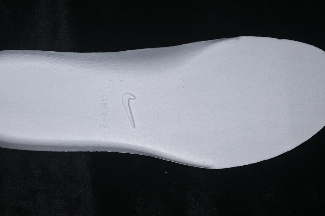 Close-up of the white removable insole with a Nike logo and embossed markings.