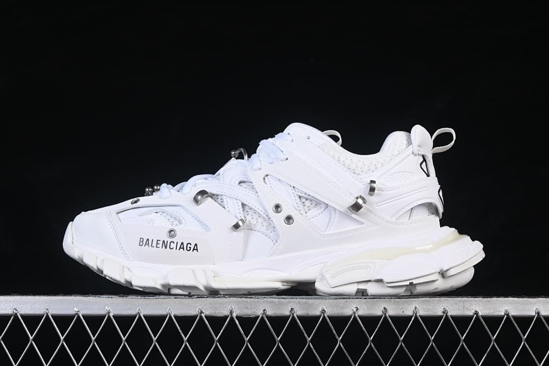 Side view of the white sneaker with layered panels and chunky sole