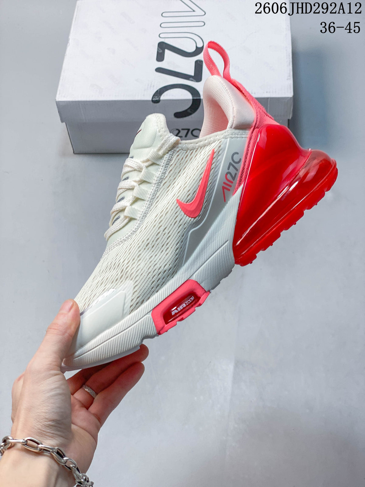 Side view of a white and red Nike Air Max 270 sneaker
