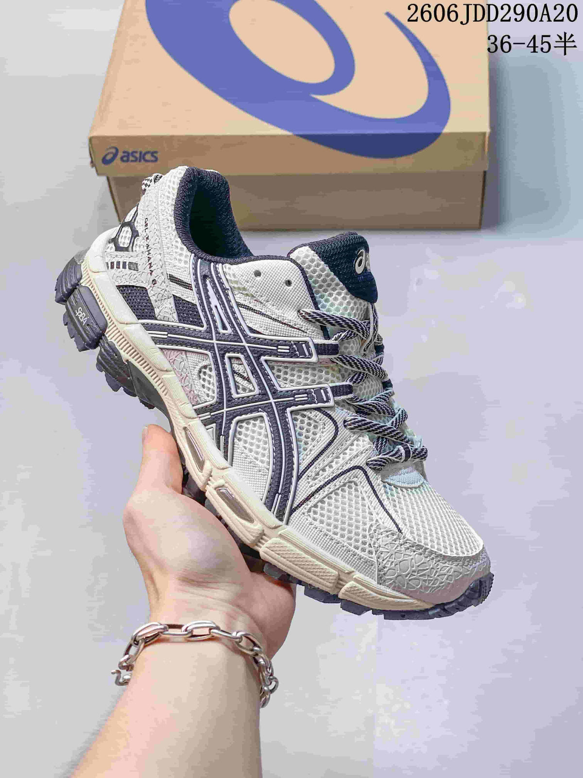 Close-up of a white ASICS Gel-Kahana 8 sneaker with dark navy side details.
