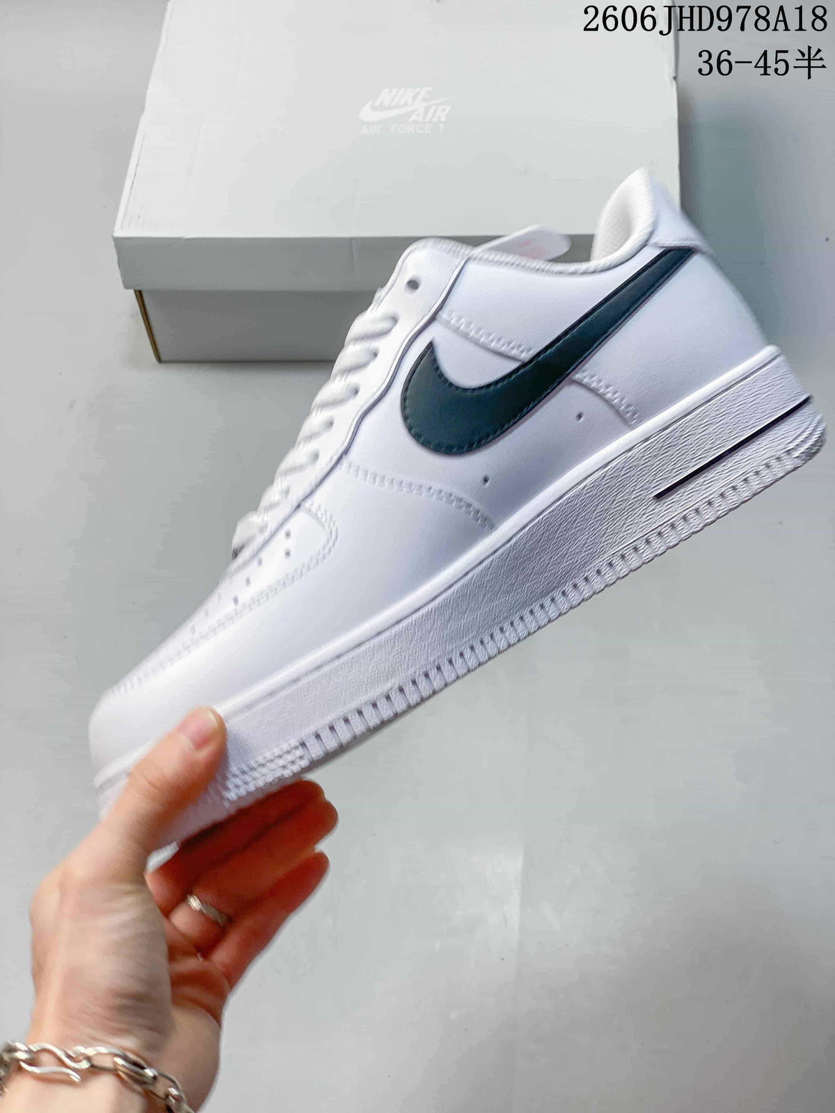 Side view of a white Nike Air Force 1 low-top sneaker with a black Swoosh