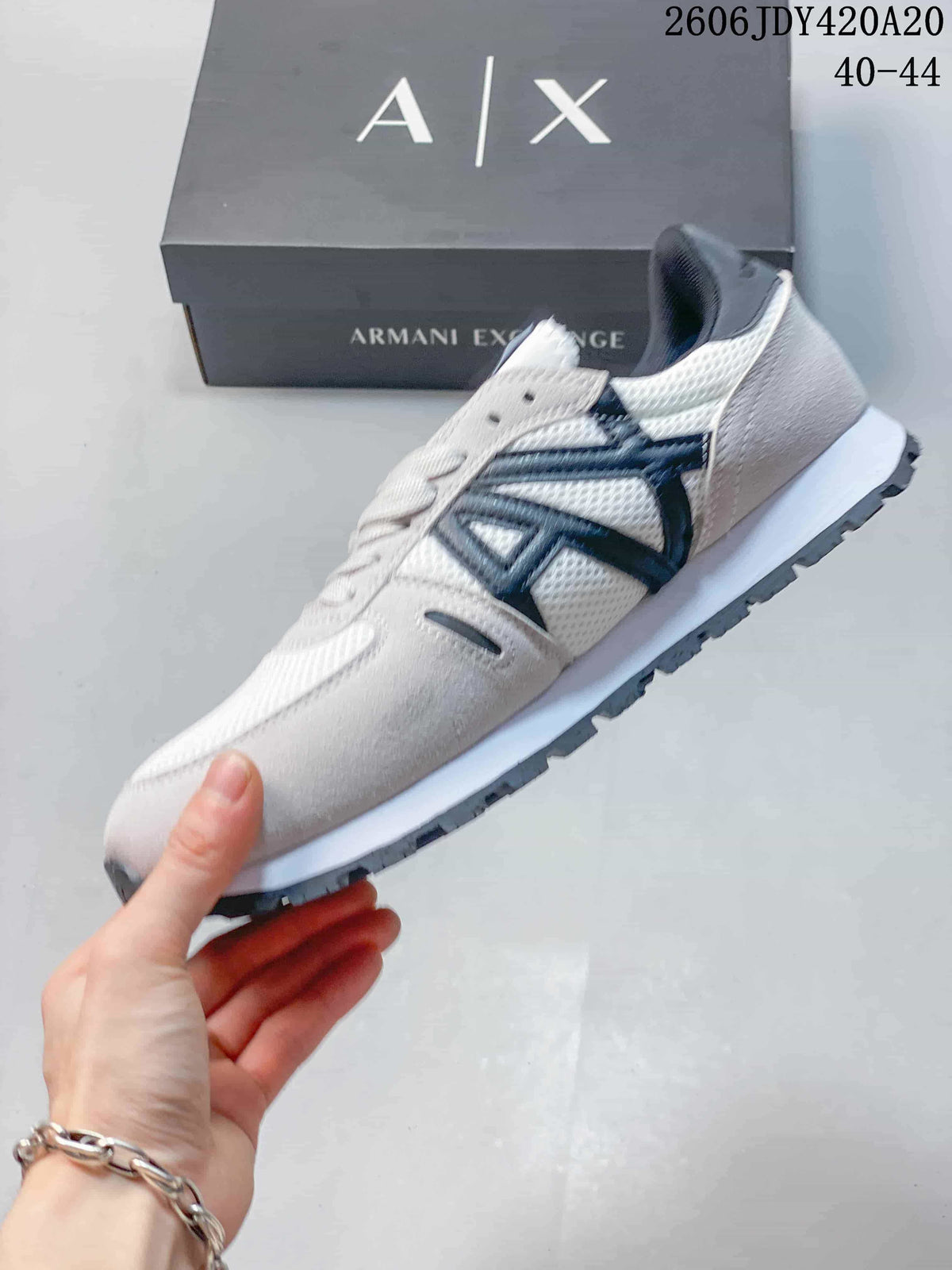 Side view of the white and gray sneaker with navy side detailing