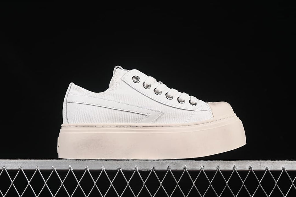Side profile of a white lace-up sneaker with a thick pale platform sole.