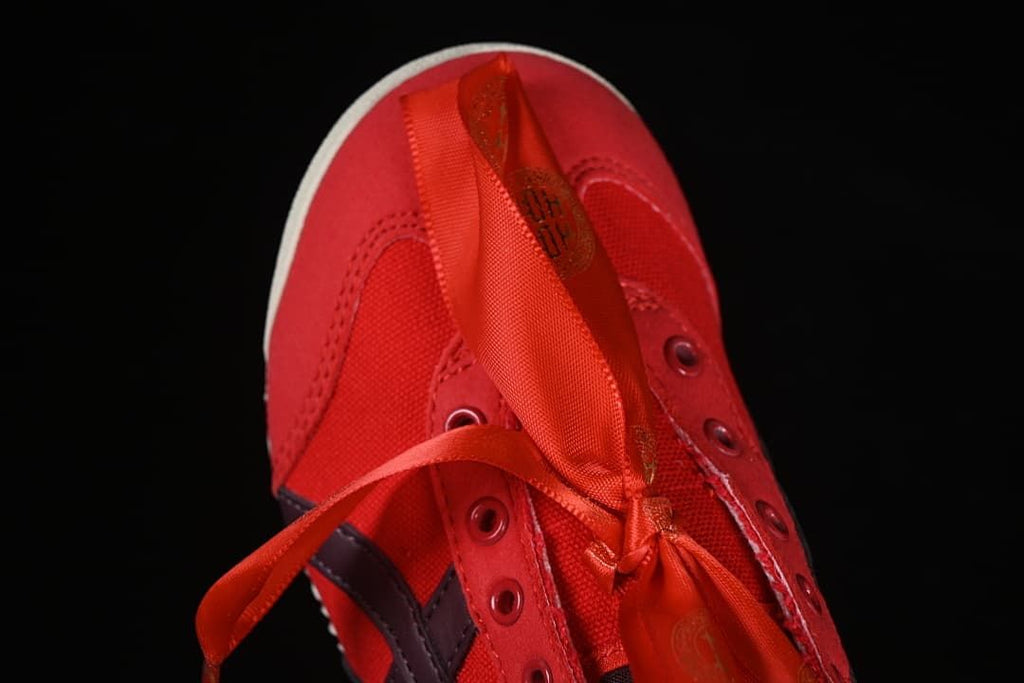 Top view of the red sneaker with ribbon laces and cord laces
