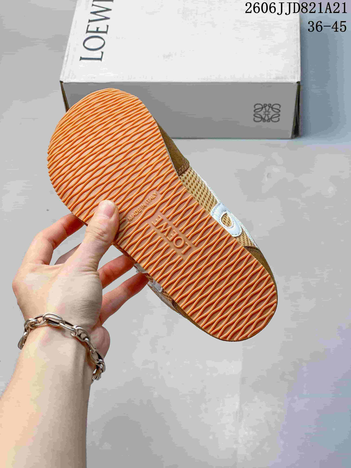 Underside of a sneaker showing an orange-toned textured outsole