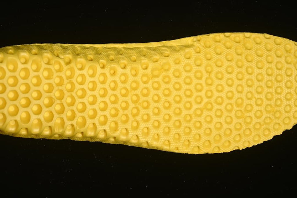 Close-up of the yellow textured outsole