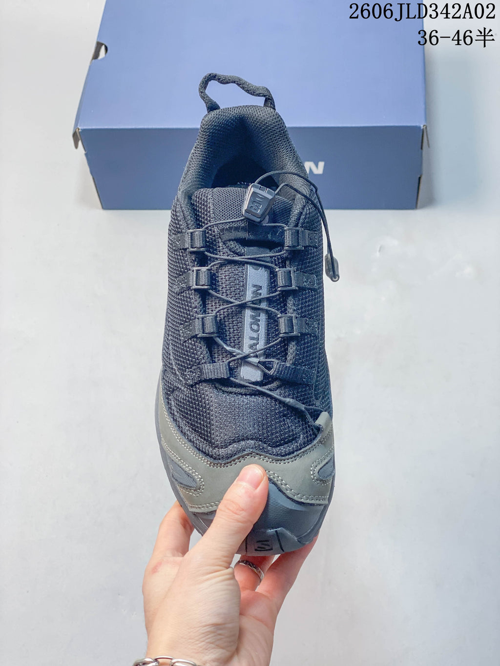 Top view showing the quick-lacing system and textured upper of a gray Salomon trail shoe.