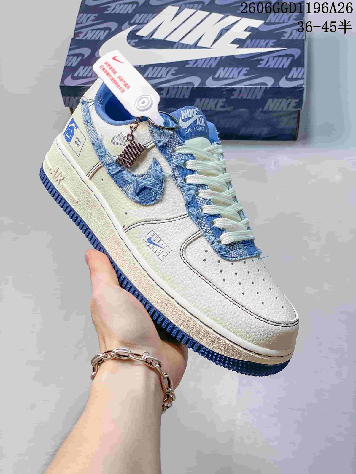 Close-up side view of a white low-top sneaker with frayed blue denim-look Swoosh and trim, plus a blue outsole.