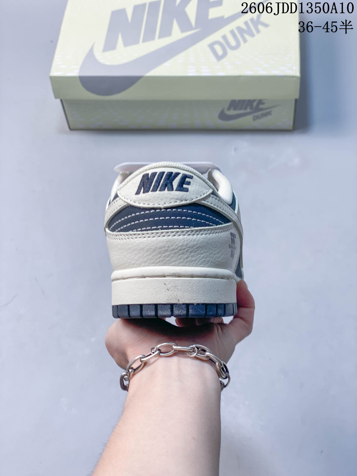 Rear view of the navy and off-white sneaker with heel branding