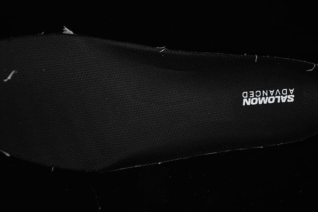 Close-up of the black insole with Salomon Advanced branding