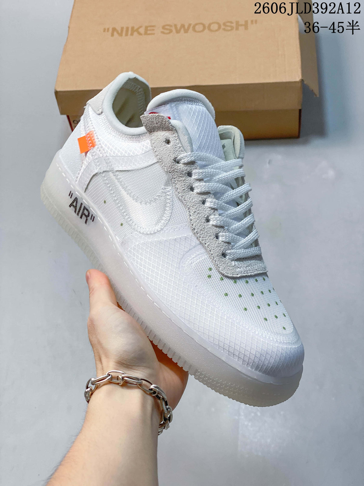 Angled side view of the white sneaker with an orange side tag