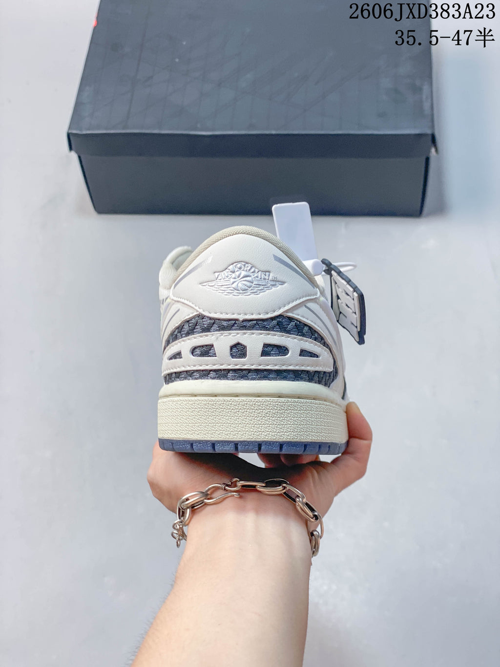 Rear view of the sneaker showing patterned heel panels and the Air Jordan Wings logo