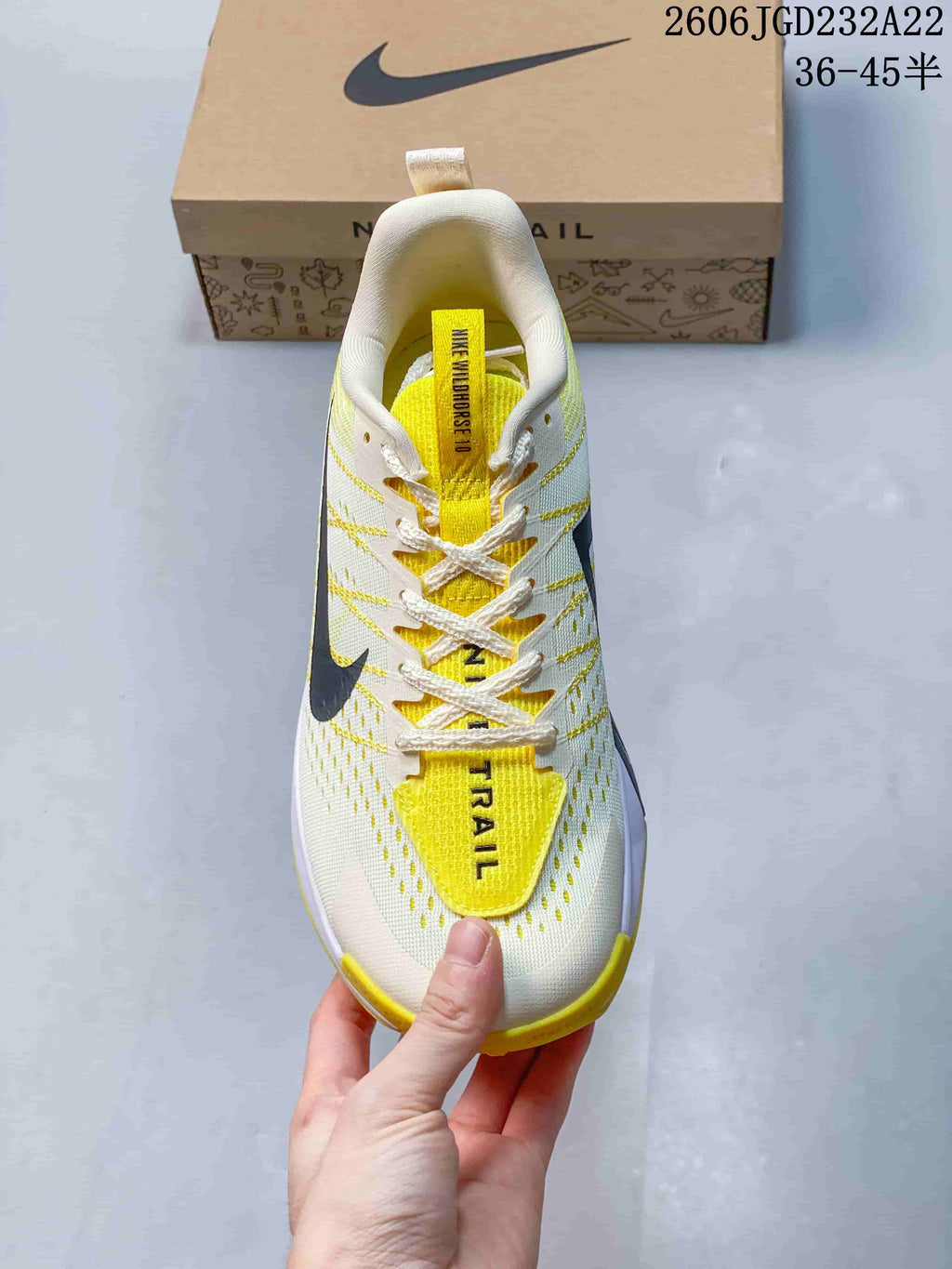 Top view showing the laces, yellow tongue, and perforated upper